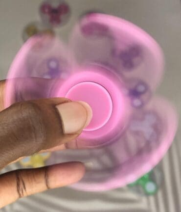 spinning pink plastic fidget spinner