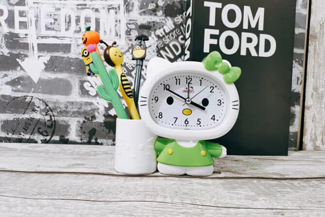 green alarm clock pen holder